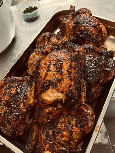 Trays of whole roasted chickens