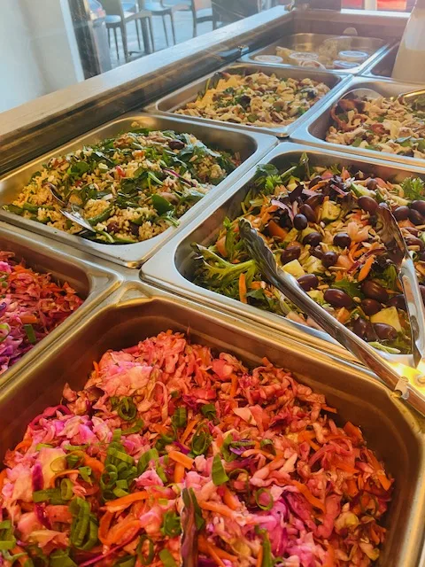 Trays of fresh salads on the counter