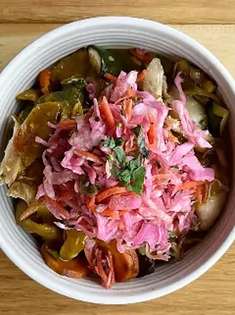 Curry bowl topped with pickled slaw