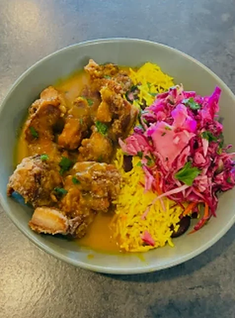 Chicken curry bowl with creole rice and pickled slaw